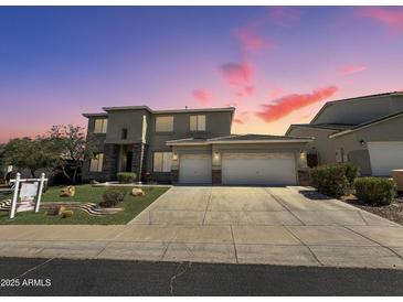 Stunning two-story home featuring a 3-car garage, desert landscaping, and a picturesque sunset backdrop at 6619 W Cordia Ln, Phoenix, AZ 85083