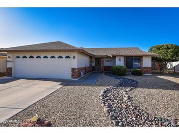 Charming single-story home featuring a low-maintenance landscape, complemented by neutral tones and a two-car garage at 7916 E Naranja Ave, Mesa, AZ 85209
