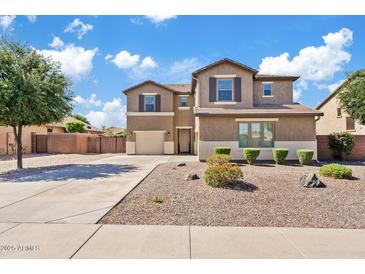 Two-story home features a two-car garage, neutral stucco, desert landscaping, and a concrete driveway at 11129 E Reginald Ave, Mesa, AZ 85212