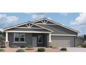 Beautiful single story home with neutral color scheme, a covered porch, and a two car garage at 11796 N Vanero Ct, Maricopa, AZ 85139