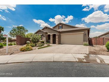 Beautiful single story home with a brick driveway and stone pillars at 1228 W Snowbell Ave, Queen Creek, AZ 85140