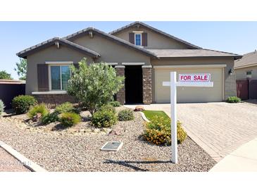 Charming single-story home with a well-maintained landscape, desert rock, and a For Sale sign at 1228 W Snowbell Ave, Queen Creek, AZ 85140