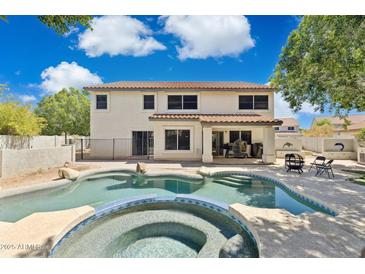 Beautiful backyard features a sparkling pool and spa, perfect for relaxing and entertaining at 12748 N 57Th Dr, Glendale, AZ 85304