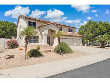 Charming two-story home with a three-car garage and desert landscaping at 12748 N 57Th Dr, Glendale, AZ 85304