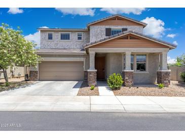 Charming two-story home boasts a well-maintained yard and inviting front porch with stone accents at 2741 S Gordon --, Mesa, AZ 85209