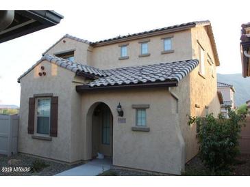 Charming two-story home featuring an arched entryway, tile roof, and neutral stucco exterior at 5345 W Marcus Dr, Phoenix, AZ 85083