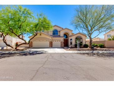 Charming two-story home features a three-car garage, mature landscaping, and a welcoming entrance at 7421 S 25Th Ln, Phoenix, AZ 85041