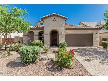 Beautiful single-Gathering home featuring desert landscaping and an arched entryway at 9747 W Sands Dr, Peoria, AZ 85383