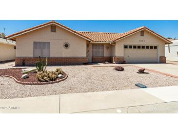 Charming single-story home with a terracotta roof, neutral stucco, and low-maintenance desert landscaping at 2005 Leisure World --, Mesa, AZ 85206