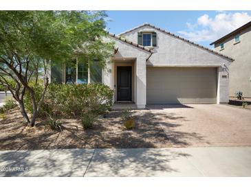 Inviting single-Gathering home with a desert-landscaped front yard and a brick-paved driveway at 20644 W Mariposa St, Buckeye, AZ 85396