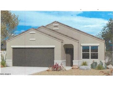 Charming single-story home featuring neutral colors, a two-car garage and simple desert landscaping at 25602 W Coles Rd, Buckeye, AZ 85326