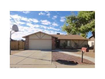 Charming single-story home with brick accents, a two-car garage, and a well-maintained front yard at 3121 W Laurie Ln, Phoenix, AZ 85051
