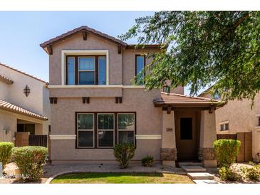 Charming two-story home features a covered entrance and well-maintained landscaping at 3449 E Sheffield Rd, Gilbert, AZ 85296