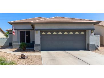 Charming single-story home featuring a gray two-car garage and a well-maintained desert landscape at 3668 E Derringer Way, Gilbert, AZ 85297