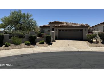 Charming single-story home featuring a tile roof, desert landscaping, and a two-car garage at 7979 E Princess Dr # 8, Scottsdale, AZ 85255