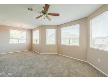 Spacious carpeted bedroom features large windows providing ample natural light and views at 9820 N Central Ave # 212, Phoenix, AZ 85020