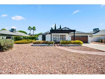 Charming single-story home featuring a pergola, brick accents, and well-maintained landscaping at 13207 N 55Th Ave, Glendale, AZ 85304