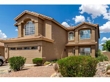 Two-story home featuring a tile roof, desert landscaping, and an attached two-car garage at 16823 S 24Th Pl, Phoenix, AZ 85048