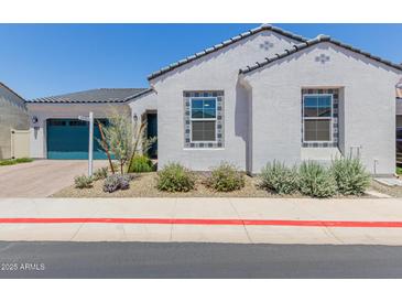Charming single-story home featuring a blue garage door and decorative tile accents around the windows at 3852 E Bartlett Way, Chandler, AZ 85249