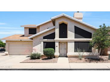 Charming stucco home with a two-car garage and well-maintained landscaping, perfect for Gathering living at 4210 W Rosemonte Dr, Glendale, AZ 85308