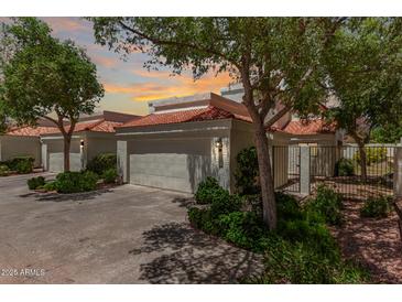 Charming single-story home with a two-car garage, a red tile roof, and well-maintained landscaping at 4225 N 21St St # 22, Phoenix, AZ 85016
