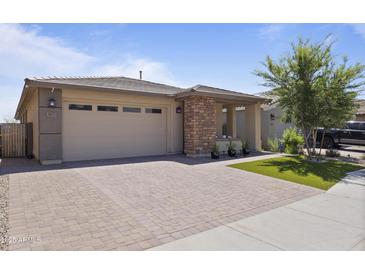 Charming single-Gathering home boasts a large garage and a beautifully paved driveway, creating a welcoming curb appeal at 5871 N 187Th Ln, Litchfield Park, AZ 85340