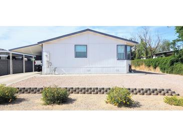 Charming single-story home featuring a carport and low-maintenance landscaping at 8902 E Baltimore St, Mesa, AZ 85207