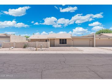 Charming single-story home with well-maintained landscaping and a two-car garage at 1055 N 86Th Pl, Scottsdale, AZ 85257