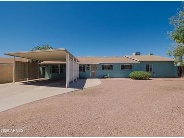Charming single-story home with a carport and low-maintenance landscaping at 1637 W University Dr, Mesa, AZ 85201