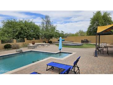 Backyard oasis with a pool, outdoor kitchen, fire pit, and lounge area, perfect for entertaining at 1766 N Channing --, Mesa, AZ 85207