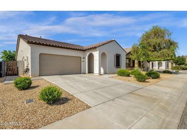 Charming single-story home featuring a two-car garage, neutral stucco, and low-maintenance desert landscaping at 4595 W Foldwing Dr, San Tan Valley, AZ 85144