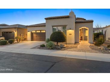 Inviting single-story home featuring a neat front yard, a two-car garage, and an arched entryway at 70 E Kennedia Dr, Queen Creek, AZ 85140