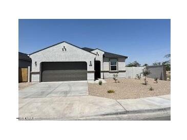 Charming single-story home with a two-car garage and low-maintenance desert landscaping at 91 S Collier Ln, Casa Grande, AZ 85122