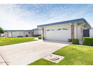 Charming single-story home with attached two-car garage and well-maintained landscaping at 10619 W Loma Blanca Dr, Sun City, AZ 85351
