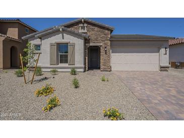 Charming single-story home with stone accents and desert landscaping at 11002 N 164Th Dr, Surprise, AZ 85388
