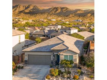 Charming single-Gathering home with a two-car garage and desert landscaping with mountain views at 16551 W Winston Dr, Goodyear, AZ 85338