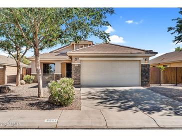 Charming single-Gathering home with a two-car garage, desert landscaping, and stone accents at 2551 W Sawtooth Way, San Tan Valley, AZ 85144