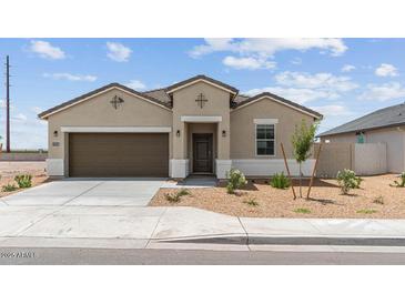 Charming single-story home with a two-car garage and desert landscaping at 38080 W Bello Ln, Maricopa, AZ 85138