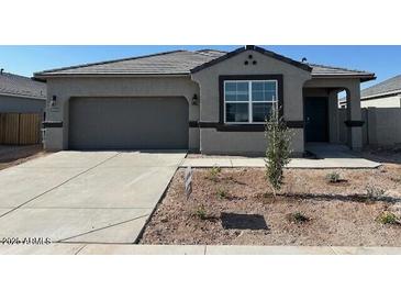 Charming single-story home with a well-maintained yard, spacious driveway, and a two-car garage at 38100 W Bello Ln, Maricopa, AZ 85138