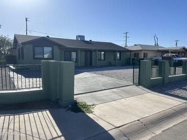 Charming single-story home featuring a landscaped yard and a secure gated entrance at 4602 N 47Th N Ave, Phoenix, AZ 85031