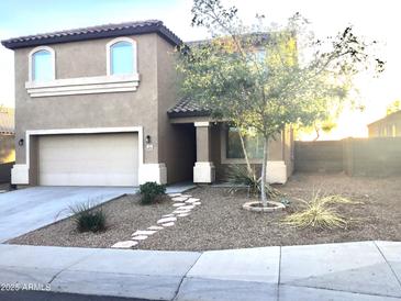 Charming two-story home featuring a well-maintained front yard and attached two-car garage at 4722 S 238Th Ln, Buckeye, AZ 85326
