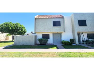 Exterior view of a two story townhouse with a low maintenance yard and gray colored front door at 4752 W Palo Verde Dr, Glendale, AZ 85301