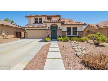 Charming two-story home with landscaped front yard, rock accents, and tiled roof at 597 S 221St Dr, Buckeye, AZ 85326