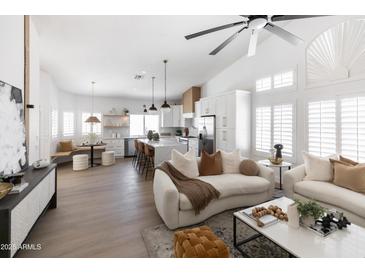 Bright, open-concept living room showcasing modern design with kitchen island, and stylish furniture at 802 N Lisbon Dr, Chandler, AZ 85226