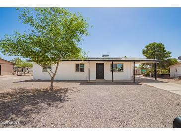 Charming single-story home featuring a gravel yard, covered entry, and convenient covered parking at 10693 N Arapaho Dr, Casa Grande, AZ 85122