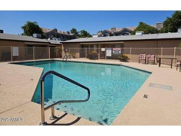 Outdoor community pool with pristine, sparkling water and handicap accessible railings at 1622 E Campbell Ave # L, Phoenix, AZ 85016