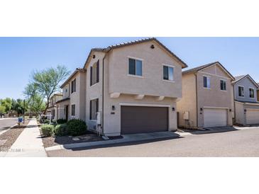 Charming two-story home featuring a neutral color palette, two car garage, and well maintained landscaping at 2668 N 73Rd Gln, Phoenix, AZ 85035