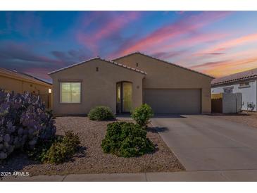 Charming single-story home featuring desert landscaping and an attached two-car garage at 42406 W Posada Dr, Maricopa, AZ 85138