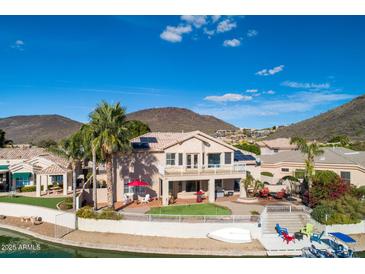 Stunning backyard with lush landscaping, patio, and private boat dock access to the canal at 5281 W Quail Ave, Glendale, AZ 85308