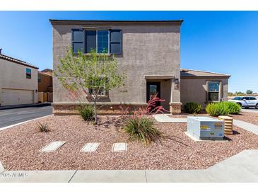 Charming two-story home with a landscaped front yard and neutral-colored exterior at 8208 W Albeniz Pl, Phoenix, AZ 85043